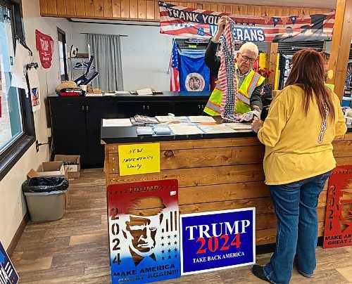 ADAM TREUSCH / FREE PRESS
George Frankberg folds a dress being bought by Tammy Marshall at the Trump Store in Lake Park, Minn., on Saturday. 

