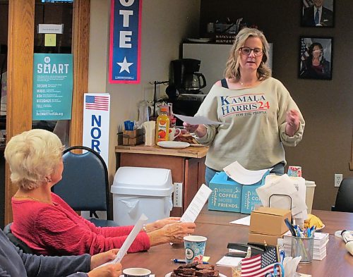 ADAM TREUSCH / FREE PRESS
Volunteer Amy Jacobson speaks at a meeting while Margaret Tinnes (left) and others listen at the Democratic offices in Fargo on Saturday.
