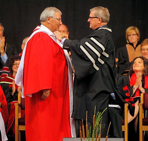 University of Winnipeg convication. Murray Sinclair is given an degree by Lloyd Axworthy. He spoke to the students.  Oct. 16, 2011 (BORIS MINKEVICH / WINNIPEG FREE PRESS)