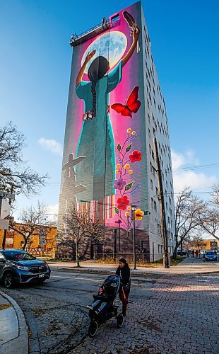 JOHN WOODS / FREE PRESS
A pedestrian passes a fifteen storey high mural on the side of 444 Kennedy by artist Jeannie White Bird is photographed Monday November 4, 2024. The mural which is named Giizaagiigo, an Anishinaabemowin word meaning you are loved, was unveiled on Friday.

Reporter: s/u