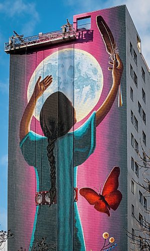 JOHN WOODS / FREE PRESS
A pedestrian passes a fifteen storey high mural on the side of 444 Kennedy by artist Jeannie White Bird is photographed Monday November 4, 2024. The mural which is named Giizaagiigo, an Anishinaabemowin word meaning you are loved, was unveiled on Friday.

Reporter: s/u