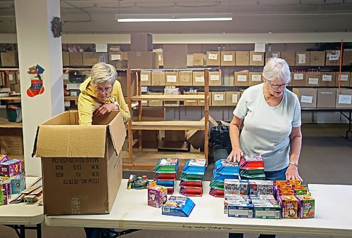 Mieke Bartlette and Linda Gillis sort through toys at the Brandon-Westman Christmas Cheer headquarters in the basement of the Library/Arts Building on Tuesday. Bartlette and Gillis co-ordinate the purchasing of toys for hampers, the wrapping of gifts and the packing of hampers. (Tim Smith/The Brandon Sun)