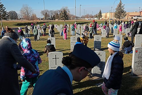 05112024
Students places poppies at the base of military grave stones during the annual No Stone Left Alone event at the Brandon Cemetery on Tuesday morning. Hundreds, including students from multiple Brandon school&#x2019;s, took part in the event meant to honour the sacrifice and service of soldiers in Canada's military. (Tim Smith/The Brandon Sun)