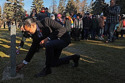 05112024
Manitoba Premier Wab Kinew places a poppy at the base of a headstone during the annual No Stone Left Alone ceremony at the Brandon Cemetery on Tuesday morning. Hundreds, including students from multiple Brandon school&#x2019;s, took part in the event meant to honour soldiers who lost their lives in wars. 
(Tim Smith/The Brandon Sun)