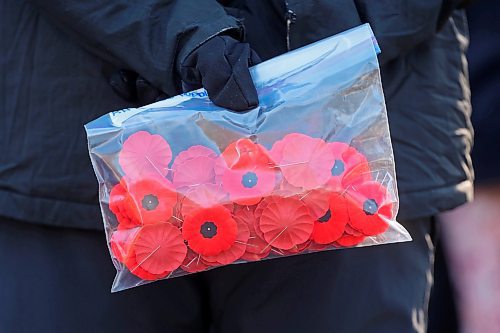 05112024
An attendee holds a bag of poppies during the annual No Stone Left Alone ceremony at the Brandon Cemetery on Tuesday morning. Hundreds, including students from multiple Brandon school&#x2019;s, took part in the event meant to honour the sacrifice and service of soldiers in Canada's military. (Tim Smith/The Brandon Sun)