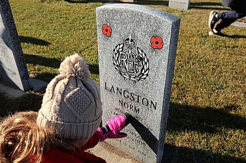 05112024
Students places poppies at the base of military grave stones during the annual No Stone Left Alone event at the Brandon Cemetery on Tuesday morning. Hundreds, including students from multiple Brandon school&#x2019;s, took part in the event meant to honour the sacrifice and service of soldiers in Canada's military. (Tim Smith/The Brandon Sun)