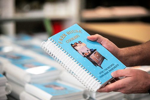 MIKAELA MACKENZIE / FREE PRESS
	
Gateway Group operations manager Rene DesJarlais shows a coil-bound recipe book in their manufacturing and bookbinding facility in Winnipeg on Thursday, Nov. 7, 2024.

For Aaron Epp story.
Winnipeg Free Press 2024