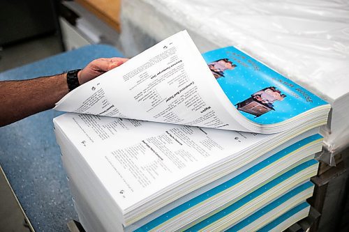 MIKAELA MACKENZIE / FREE PRESS
	
Gateway Group operations manager Rene DesJarlais shows pages for coil-bound recipe books in their manufacturing and bookbinding facility in Winnipeg on Thursday, Nov. 7, 2024.

For Aaron Epp story.
Winnipeg Free Press 2024