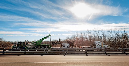 MIKE DEAL / FREE PRESS
Workers trying to haul a tractor-trailer out of a ditch adjacent to a Trans-Canada Highway bridge over the Assiniboine River near St. Fran&#xe7;ois Xavier west of Winnipeg Thursday afternoon after a collision occurred Wednesday.
241107 - Thursday, November 07, 2024.