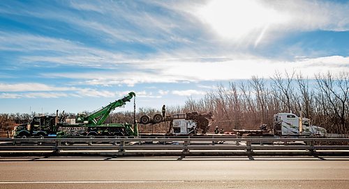 MIKE DEAL / FREE PRESS
Workers trying to haul a tractor-trailer out of a ditch adjacent to a Trans-Canada Highway bridge over the Assiniboine River near St. Fran&#xe7;ois Xavier west of Winnipeg Thursday afternoon after a collision occurred Wednesday.
241107 - Thursday, November 07, 2024.