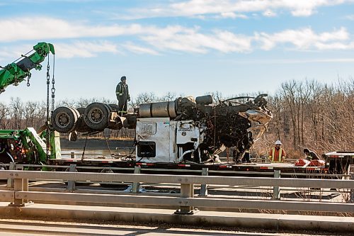 MIKE DEAL / FREE PRESS
Workers trying to haul a tractor-trailer out of a ditch adjacent to a Trans-Canada Highway bridge over the Assiniboine River near St. Fran&#xe7;ois Xavier west of Winnipeg Thursday afternoon after a collision occurred Wednesday.
241107 - Thursday, November 07, 2024.