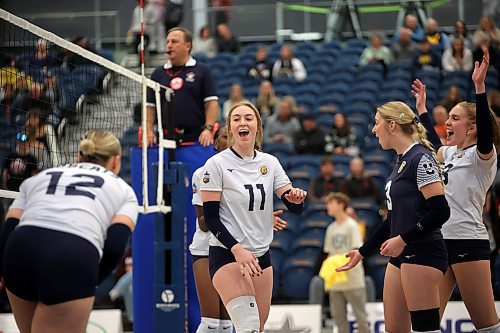 Carly Thomson (11) of the Brandon University Bobcats celebrates a point with teammates during the Bobcats home-opener against the University of Saskatchewan Huskies at the BU Healthy Living Centre on Friday evening. The Huskies swept the Bobcats in three sets. See story on Page B1. (Tim Smith/The Brandon Sun)