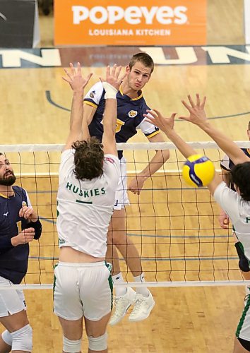 Brandon's Philipp Lauter attacks against a Saskatchewan double block during their Canada West men's volleyball match at the Healthy Living Centre on Friday. (Thomas Friesen/The Brandon Sun)