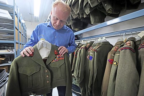 RCA Museum Director Andrew Oakden holds a uniform that once belonged to Lt.-General Guy G. Simonds, a famous Canadian officer who led the Canadian military campaign in North-Western Europe during the Second World War. His uniform, and those of many other Canadian soldiers, are stored in the archive room of the RCA Museum. (Matt Goerzen/The Brandon Sun)