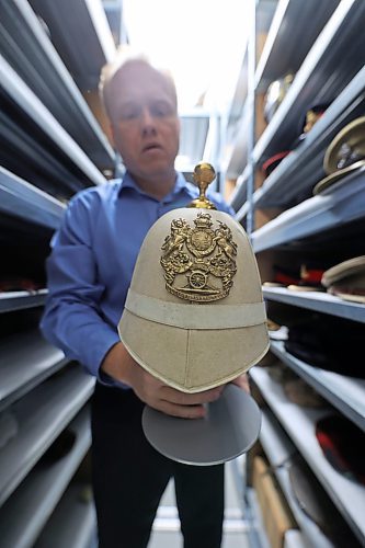 RCA Museum director Andrew Oakden holds a Canadian Gunners helmet from the late 1800s that sports the Canadian version of the Royal Arms that were first granted to the British Royal Regiment of Artillery as a badge by warrant of His Majesty, King William IV. When the Canadian Gunners adopted the badge, the motto &quot;Ubique&quot; on the plate was replaced with the name &quot;Canada.&quot; This Canadian military artifact, along with several other military paraphernalia that are in storage or on display at the museum in CFB Shilo. (Matt Goerzen/The Brandon Sun)