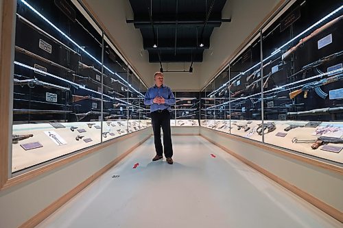 RCA Museum director Andrew Oakden stands in the middle of the Gun Vault room, an exhibit in the museum that contains more than 90 small arms and light weapons, starting with muskets and working its way to more modern rifles. The museum has arranged the artifacts to show technological development over time.  (Matt Goerzen/The Brandon Sun)