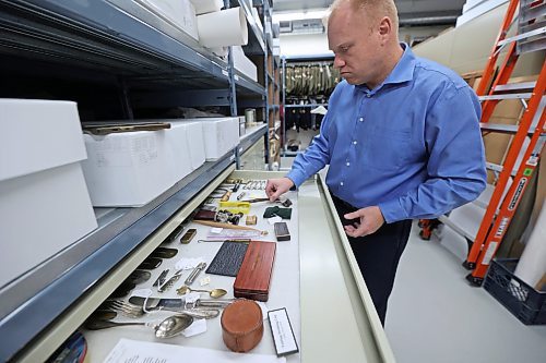 RCA Museum director Andrew Oakden opens a storage cabinet holding various items in the museum's collection that a typical soldier on the front lines in the First World War that were given by the military. The museum has an extensive collection of war memorabilia both on display and in its archival room, including uniforms, photos, pins, weapons and other paraphernalia. (Matt Goerzen/The Brandon Sun)