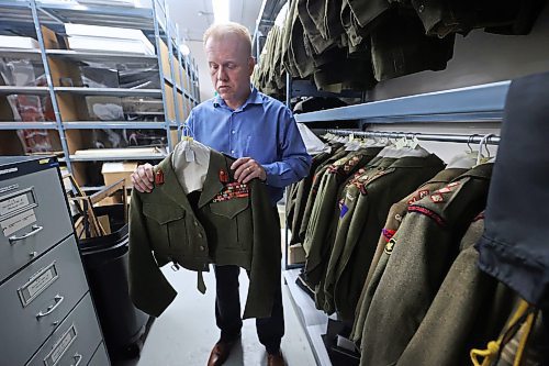 RCA Museum Director Andrew Oakden holds a uniform that once belonged to Lt.-General Guy G. Simonds, a famous Canadian officer who led the Canadian military campaign in North-Western Europe during the Second World War. His uniform, and those of many other Canadian soldiers, are stored in the archive room of the RCA Museum. (Matt Goerzen/The Brandon Sun)