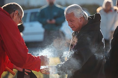 08112024
Dakota knowledge keeper Frank Tacan leads a smudge for participants in the Indigenous Veterans Day ceremony at the teepee in Errol Black Park on Rosser Avenue East on Friday morning. The ceremony was organized by the Brandon Friendship Centre, included a pipe ceremony and prayer, and was followed by a feast. 
(Tim Smith/The Brandon Sun)