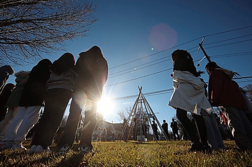 08112024
Students listen to Dakota knowledge keeper, cultural worker and elder Frank Tacan speak during an Indigenous Veterans Day ceremony at the teepee in Errol Black Park on Rosser Avenue East on Friday morning. The ceremony was organized by the Brandon Friendship Centre, included a pipe ceremony and prayer, and was followed by a feast. 
(Tim Smith/The Brandon Sun)