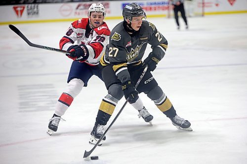 11112024
Luke Shipley #27 of the Brandon Wheat Kings makes a shot on net as Logan Wormald #18 of the Lethbridge Hurricanes tries to knock him off the puck during WHL action at Westoba Place on Monday afternoon.  (Tim Smith/The Brandon Sun)