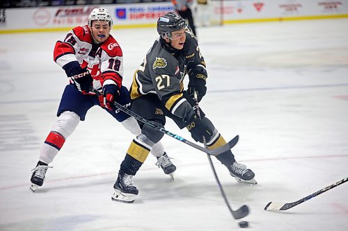 11112024
Luke Shipley #27 of the Brandon Wheat Kings makes a shot on net as Logan Wormald #18 of the Lethbridge Hurricanes tries to knock him off the puck during WHL action at Westoba Place on Monday afternoon.  (Tim Smith/The Brandon Sun)