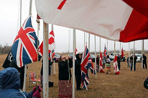 11112024
Community members pitch in to take down the flags that fly at the war memorial at Sioux Valley Dakota Nation&#x2019;s Pow Wow grounds following the Remembrance Day service at the SVDN Community Centre on Monday. The flags are raised for the weekend of Sioux Valley&#x2019;s Pow Wow and then raised again on National Indigenous Veterans Day (November 8) and removed on Remembrance Day. 
(Tim Smith/The Brandon Sun)