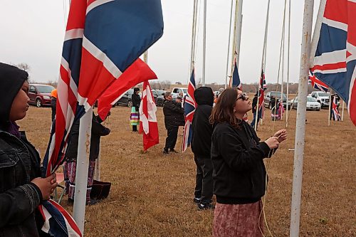 11112024
Community members pitch in to take down the flags that fly at the war memorial at Sioux Valley Dakota Nation&#x2019;s Pow Wow grounds following the Remembrance Day service at the SVDN Community Centre on Monday. The flags are raised for the weekend of Sioux Valley&#x2019;s Pow Wow and then raised again on National Indigenous Veterans Day (November 8) and removed on Remembrance Day. 
(Tim Smith/The Brandon Sun)