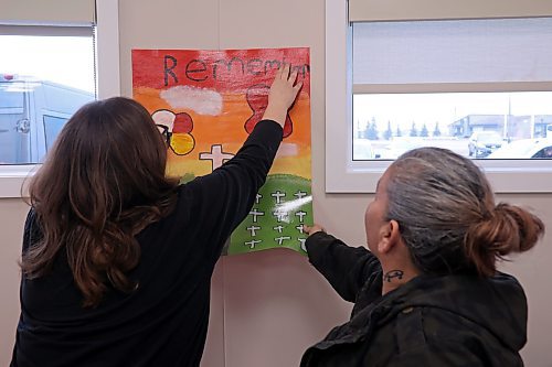 11112024
Meadow Leaming, Junior Chief of Sioux Valley High School, and her mom Roxanna Gott hang posters made by students for the Remembrance Day service at the Sioux Valley Dakota Nation Community Centre on Monday. 
(Tim Smith/The Brandon Sun)