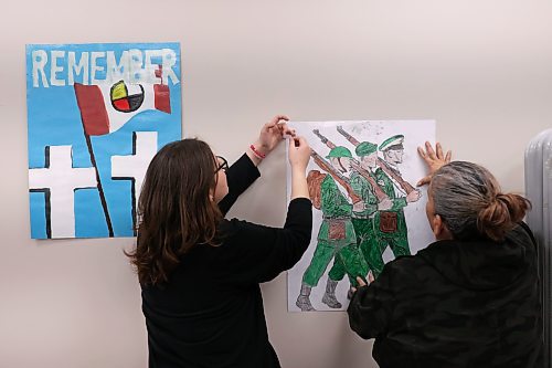 11112024
Meadow Leaming, Junior Chief of Sioux Valley High School, and her mom Roxanna Gott hang posters made by students for the Remembrance Day service at the Sioux Valley Dakota Nation Community Centre on Monday. 
(Tim Smith/The Brandon Sun)