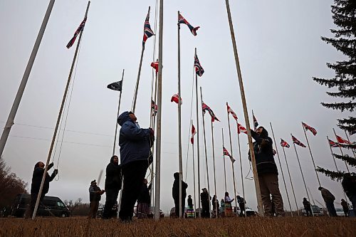 11112024
Community members pitch in to take down the flags that fly at the war memorial at Sioux Valley Dakota Nation&#x2019;s Pow Wow grounds following the Remembrance Day service at the SVDN Community Centre on Monday. The flags are raised for the weekend of Sioux Valley&#x2019;s Pow Wow and then raised again on National Indigenous Veterans Day (November 8) and removed on Remembrance Day. 
(Tim Smith/The Brandon Sun)