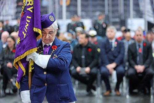 A member of the Army, Navy and Air Force Veterans stands with flag in hand as part of the Colour Party during the Remembrance Day ceremony at Brandon's Keystone Centre on Monday morning. (Matt Goerzen/The Brandon Sun)