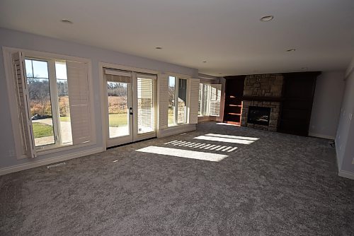 Todd Lewys / Free Press
The walk-out lower-level family room comes with a gas fireplace, adjacent flex room and a garden door leading out to a covered patio looking onto the gorgeous backyard.
