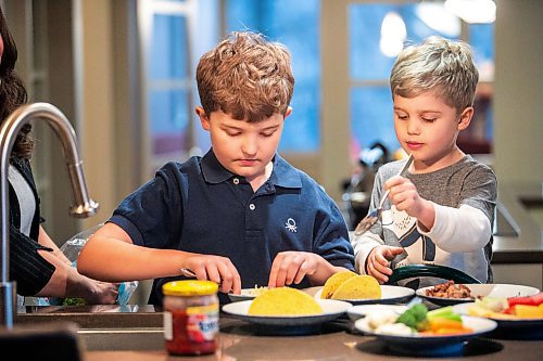 MIKAELA MACKENZIE / FREE PRESS
	
Jacob Reimer (eight) and Zavier Reimer (five) prepare bean tacos on Wednesday, Nov. 13, 2024. Mercer feels that raising her kids vegan helps them to think more about the foods they eat, about where their toys and clothes come from, and their impact on the planet. 

For Janine green page story.
Winnipeg Free Press 2024