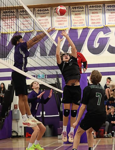 Aiden Moore sets a tight ball as Knox Smith rises up to block. (Tim Smith/The Brandon Sun)