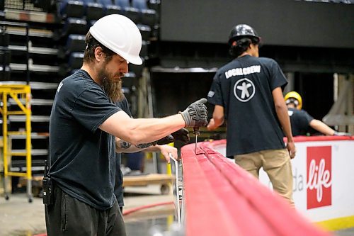 MIKE SUDOMA / FREE PRESS
Lead hand Keith Rolph pries apart the boards as the crew prepares for the Bruce Springsteen show Wednesday evening
Nov 13, 2024


