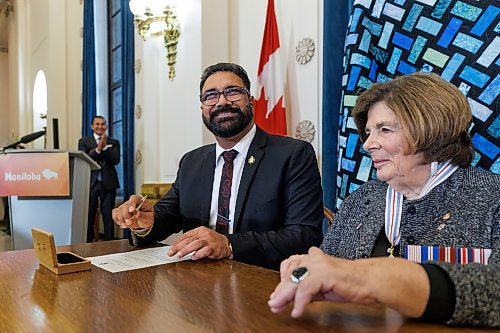 MIKE DEAL / FREE PRESS
Mintu Sandhu (MLA for The Maples) is sworn in as the minister of public service delivery signing a document with Lt.-Gov. Anita Neville as witness.
Premier Wab Kinew expanded and shuffled his cabinet after a year in office during a ceremony Wednesday morning at the Manitoba Legislative Building. Mike Moroz, the MLA for River Heights, will lead the department of innovation and new technology, an entirely new division. The other two new members of cabinet are Mintu Sandhu (the Maples), who is now minister of the delivery of public services, and Nellie Kennedy (Assiniboia), who is now minister of sport, culture, heritage and tourism.
Jamie Moses (St. Vital) is now minister of business, mining, trade and job creation.
lan Bushie (Keewatinook) is now minister of natural resources. He remains the minister of Indigenous economic development.
Glen Simard (Brandon East) is now minister of municipal and northern relations.
Lisa Naylor (Wolseley) remains minister of transportation and infrastructure but is no longer minister of consumer protection and government services, the news release stated.
Including the premier, there are now 19 cabinet members.
Reporter: Carol Sanders
241113 - Wednesday, November 13, 2024.