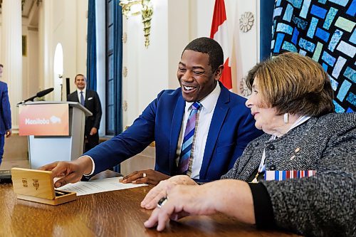 MIKE DEAL / FREE PRESS
Jamie Moses (St. Vital) is sworn in as minister of business, mining, trade and job creation signing a document with Lt.-Gov. Anita Neville as witness.
Premier Wab Kinew expanded and shuffled his cabinet after a year in office during a ceremony Wednesday morning at the Manitoba Legislative Building. Mike Moroz, the MLA for River Heights, will lead the department of innovation and new technology, an entirely new division. The other two new members of cabinet are Mintu Sandhu (the Maples), who is now minister of the delivery of public services, and Nellie Kennedy (Assiniboia), who is now minister of sport, culture, heritage and tourism.
Jamie Moses (St. Vital) is now minister of business, mining, trade and job creation.
lan Bushie (Keewatinook) is now minister of natural resources. He remains the minister of Indigenous economic development.
Glen Simard (Brandon East) is now minister of municipal and northern relations.
Lisa Naylor (Wolseley) remains minister of transportation and infrastructure but is no longer minister of consumer protection and government services, the news release stated.
Including the premier, there are now 19 cabinet members.
Reporter: Carol Sanders
241113 - Wednesday, November 13, 2024.