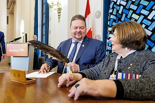 MIKE DEAL / FREE PRESS
lan Bushie (Keewatinook) is sworn in as minister of natural resources. He remains the minister of Indigenous economic development signing a document with Lt.-Gov. Anita Neville as witness.
Premier Wab Kinew expanded and shuffled his cabinet after a year in office during a ceremony Wednesday morning at the Manitoba Legislative Building. Mike Moroz, the MLA for River Heights, will lead the department of innovation and new technology, an entirely new division. The other two new members of cabinet are Mintu Sandhu (the Maples), who is now minister of the delivery of public services, and Nellie Kennedy (Assiniboia), who is now minister of sport, culture, heritage and tourism.
Jamie Moses (St. Vital) is now minister of business, mining, trade and job creation.
lan Bushie (Keewatinook) is now minister of natural resources. He remains the minister of Indigenous economic development.
Glen Simard (Brandon East) is now minister of municipal and northern relations.
Lisa Naylor (Wolseley) remains minister of transportation and infrastructure but is no longer minister of consumer protection and government services, the news release stated.
Including the premier, there are now 19 cabinet members.
Reporter: Carol Sanders
241113 - Wednesday, November 13, 2024.