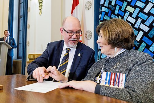 MIKE DEAL / FREE PRESS
Mike Moroz (River Heights), is sworn in as minister of innovation and new technology signing a document with Lt.-Gov. Anita Neville as witness.
Premier Wab Kinew expanded and shuffled his cabinet after a year in office during a ceremony Wednesday morning at the Manitoba Legislative Building. Mike Moroz, the MLA for River Heights, will lead the department of innovation and new technology, an entirely new division. The other two new members of cabinet are Mintu Sandhu (the Maples), who is now minister of the delivery of public services, and Nellie Kennedy (Assiniboia), who is now minister of sport, culture, heritage and tourism.
Jamie Moses (St. Vital) is now minister of business, mining, trade and job creation.
lan Bushie (Keewatinook) is now minister of natural resources. He remains the minister of Indigenous economic development.
Glen Simard (Brandon East) is now minister of municipal and northern relations.
Lisa Naylor (Wolseley) remains minister of transportation and infrastructure but is no longer minister of consumer protection and government services, the news release stated.
Including the premier, there are now 19 cabinet members.
Reporter: Carol Sanders
241113 - Wednesday, November 13, 2024.