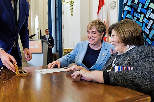 MIKE DEAL / FREE PRESS
Lisa Naylor (Wolseley) is sworn in as minister of transportation and infrastructure signing a document with Lt.-Gov. Anita Neville as witness.
Premier Wab Kinew expanded and shuffled his cabinet after a year in office during a ceremony Wednesday morning at the Manitoba Legislative Building. Mike Moroz, the MLA for River Heights, will lead the department of innovation and new technology, an entirely new division. The other two new members of cabinet are Mintu Sandhu (the Maples), who is now minister of the delivery of public services, and Nellie Kennedy (Assiniboia), who is now minister of sport, culture, heritage and tourism.
Jamie Moses (St. Vital) is now minister of business, mining, trade and job creation.
lan Bushie (Keewatinook) is now minister of natural resources. He remains the minister of Indigenous economic development.
Glen Simard (Brandon East) is now minister of municipal and northern relations.
Lisa Naylor (Wolseley) remains minister of transportation and infrastructure but is no longer minister of consumer protection and government services, the news release stated.
Including the premier, there are now 19 cabinet members.
Reporter: Carol Sanders
241113 - Wednesday, November 13, 2024.