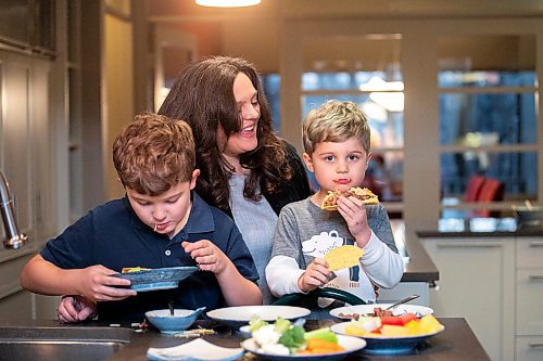 MIKAELA MACKENZIE / FREE PRESS
	
Desirae Mercer and her children, Jacob Reimer (eight) and Zavier Reimer (five), prepare bean tacos on Wednesday, Nov. 13, 2024. Mercer feels that raising her kids vegan helps them to think more about the foods they eat, about where their toys and clothes come from, and their impact on the planet. 

For Janine green page story.
Winnipeg Free Press 2024