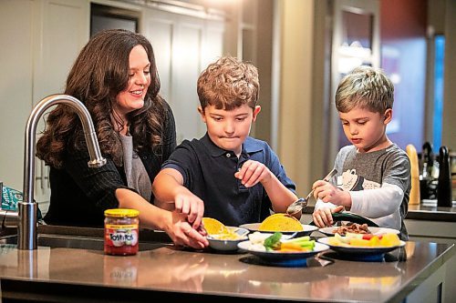 MIKAELA MACKENZIE / FREE PRESS
	
Desirae Mercer and her children, Jacob Reimer (eight) and Zavier Reimer (five), prepare bean tacos on Wednesday, Nov. 13, 2024. Mercer feels that raising her kids vegan helps them to think more about the foods they eat, about where their toys and clothes come from, and their impact on the planet. 

For Janine green page story.
Winnipeg Free Press 2024