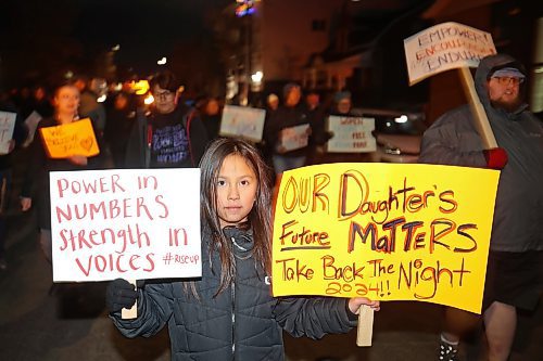 Lexi Francois, 9, carries placards while taking part in the annual Take Back The Night March in Brandon on Thursday evening. After speakers and drumming at Princess Park, marchers walked along Princess Avenue to Brandon University. November marks Domestic Violence Awareness Month and the annual march brings attention to gender-based and sexual violence. (Photos by Tim Smith/The Brandon Sun)