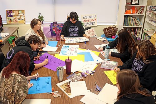 Staff members with the Women’s Resource Centre create signs and placards on Thursday afternoon for marchers to carry during Thursday evening’s Take Back The Night march. (Tim Smith/The Brandon Sun)