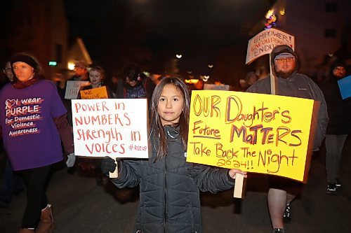 14112024
Nine-year-old Lexi Francois carries placards while taking part in the annual Take Back The Night March in Brandon on Thursday evening. After speakers and drumming at Princess Park, marchers walked along Princess Avenue to Brandon University. November marks Domestic Violence Awareness Month and the annual march brings attention to gender-based and sexual violence. (Tim Smith/The Brandon Sun)