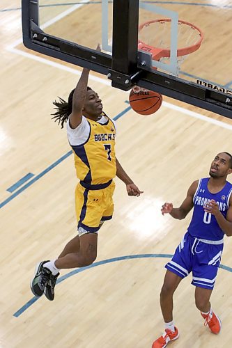 Brandon University Bobcats Jakarri Lindsey dunks as Lethbridge Pronghorns Angelo Mbituyimana looks on during their Canada West men's basketball game at the Healthy Living Centre on Friday. (Thomas Friesen/The Brandon Sun)