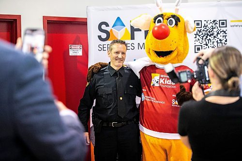 MIKAELA MACKENZIE / FREE PRESS
	
Mascot Rudy helps launch Operation Red Nose while posing for a photo with WPS impaired drivers countermeasures coordinator Stephane Fontaine in Winnipeg on Friday, Nov. 15, 2024. 

Standup.
Winnipeg Free Press 2024