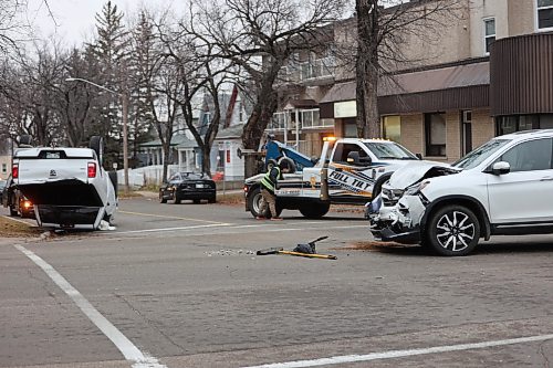 Full Tilt Towing & Transport employee working at a collision scene on Princess Ave. on Saturday morning. The collision was between a White RAM truck and a Honda Pilot SUV. (Abiola Odutola/The Brandon Sun)