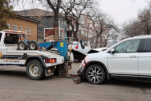 Full Tilt Towing & Transport truck pulls a Honda Pilot SUV from the collision scene on Princess Ave. on Saturday morning. The collision was between a White RAM truck and a Honda Pilot SUV. (Abiola Odutola/The Brandon Sun)